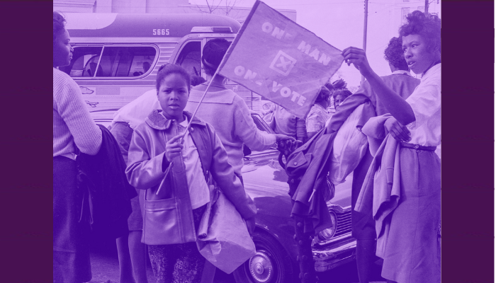 "A young girl holds a flag in support of voting rights on the day before the Selma to Montgomery March arrived at the Alabama State Capitol on March 24, 1965. For decades, those rights were suppressed through barriers such as poll taxes and literacy tests."
