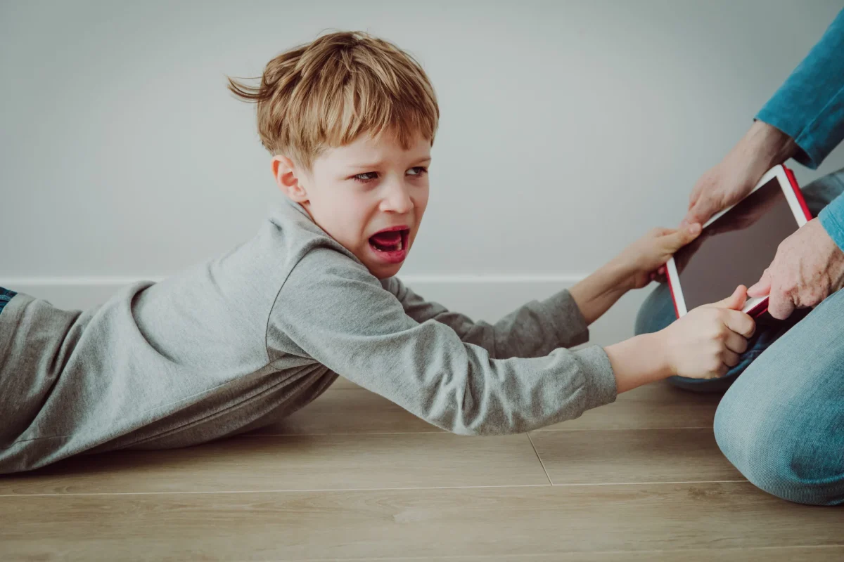 Photo Credits: The Lasso 
Ipad being torn away from child