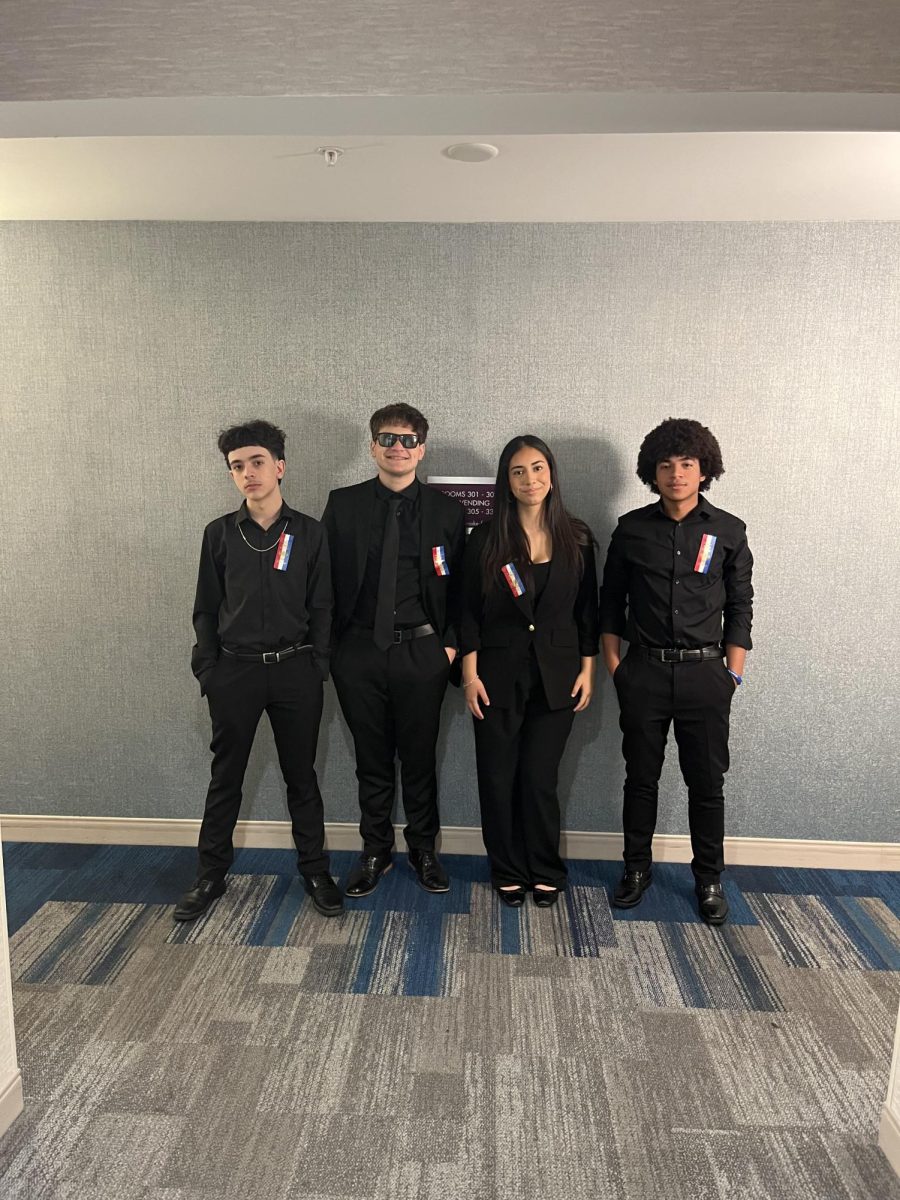 Nathan Webber and Anyssa posing with their Team at a Debate competition.