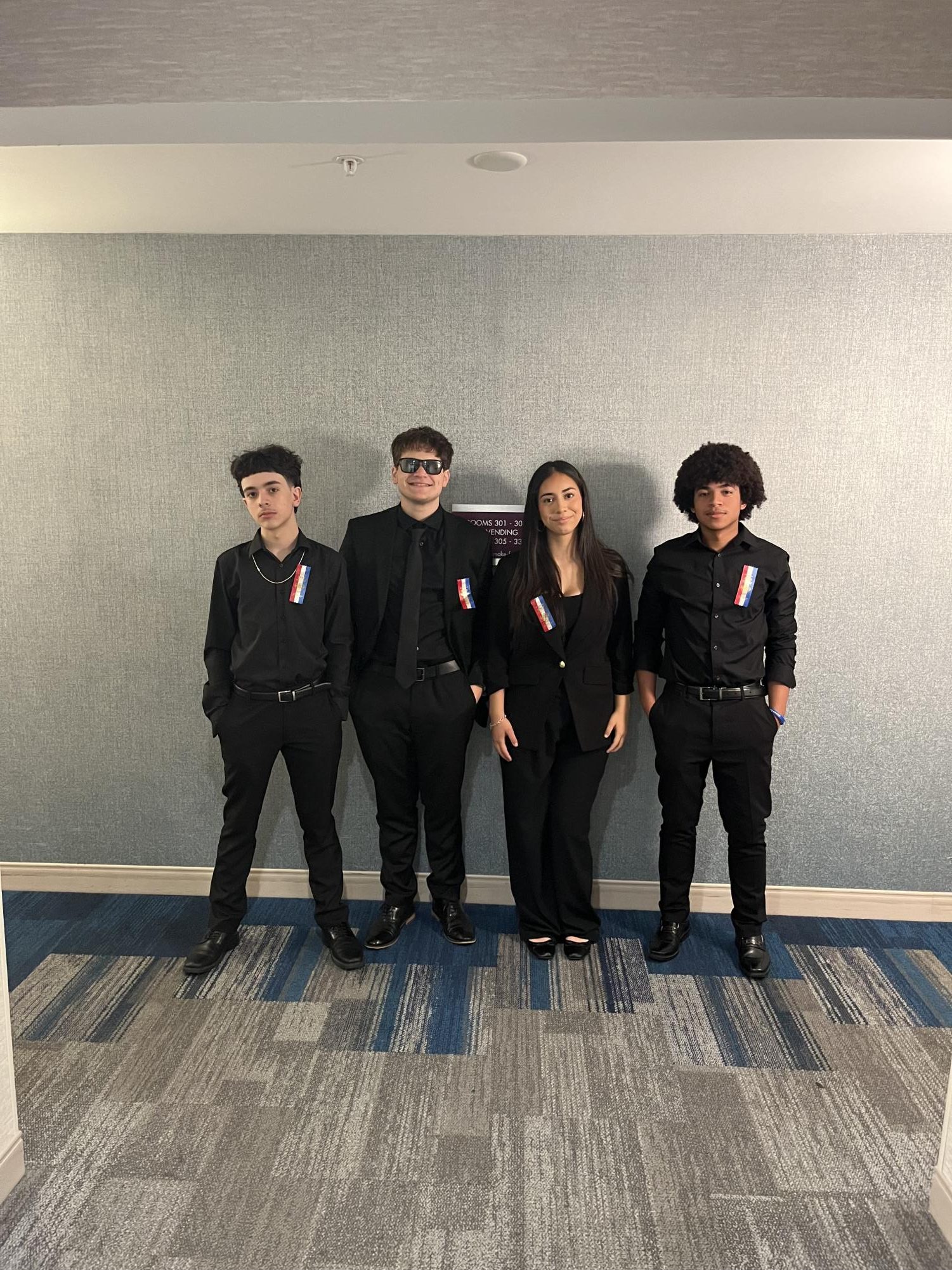 Nathan Webber and Anyssa posing with their Team at a Debate competition.